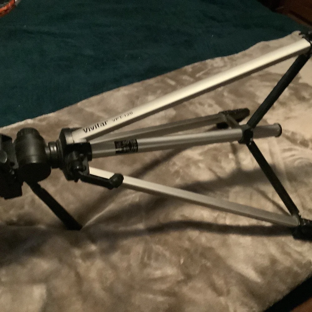 Camera tripod, adjustable.